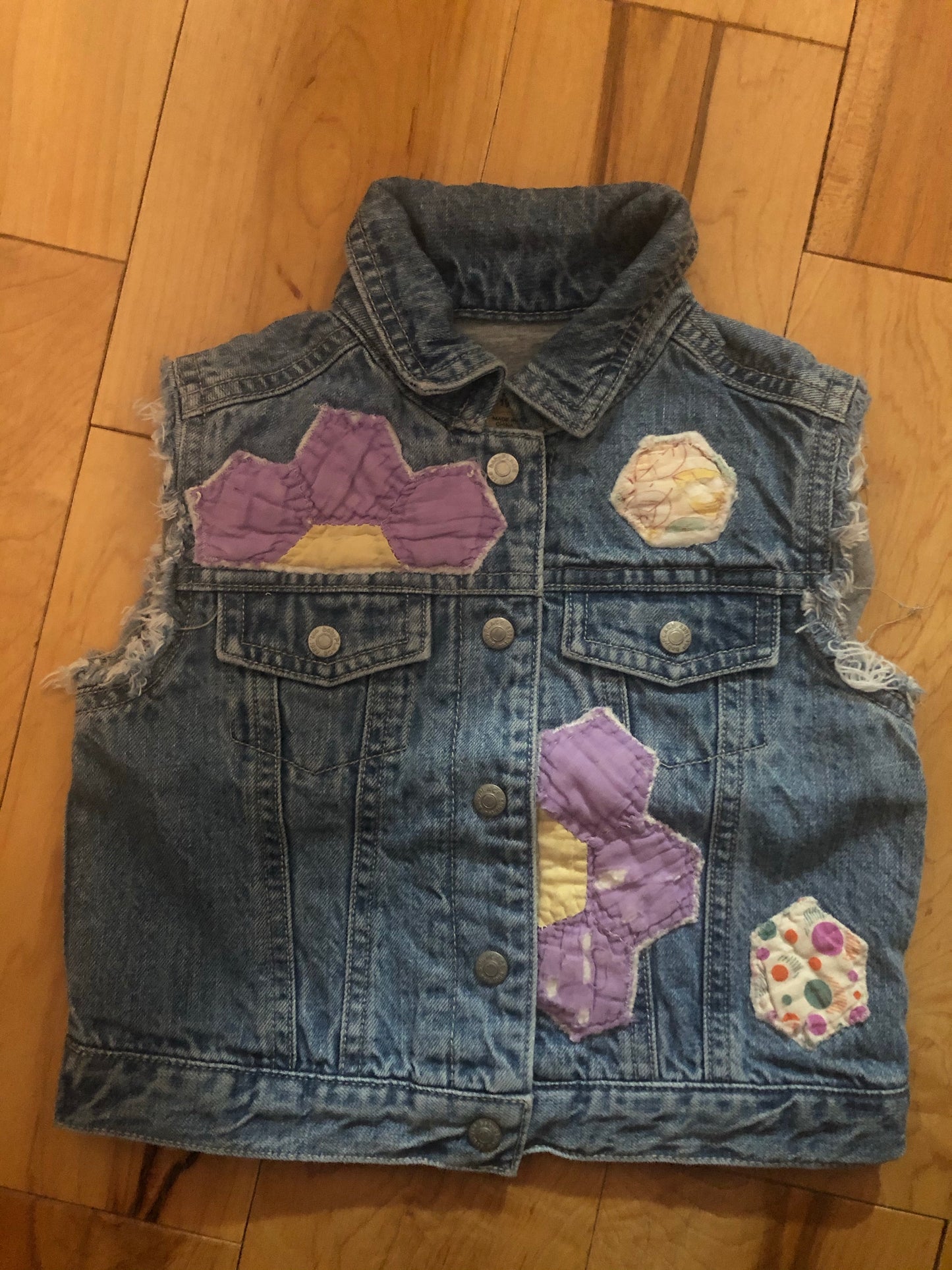 front-side of denim vest with stitched florals